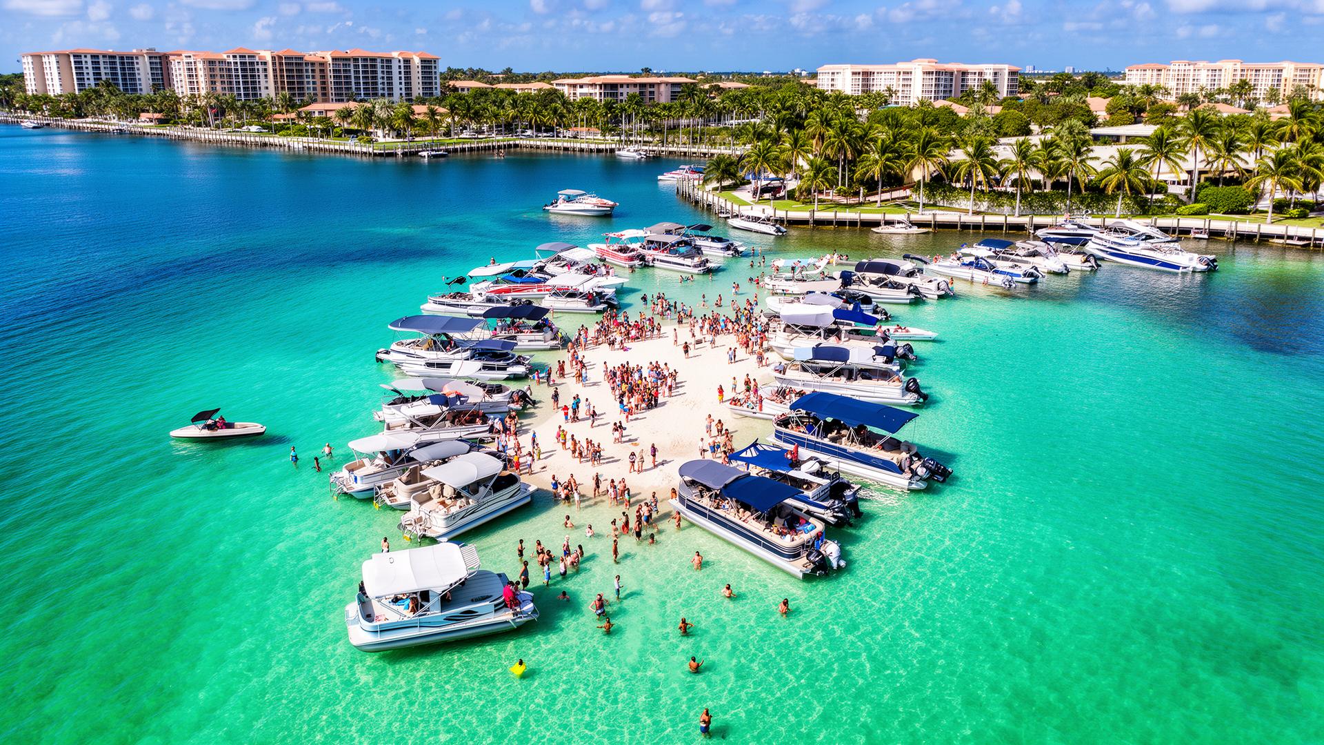 Aerial drone view of Lake Boca Raton sandbar with pontoon boats